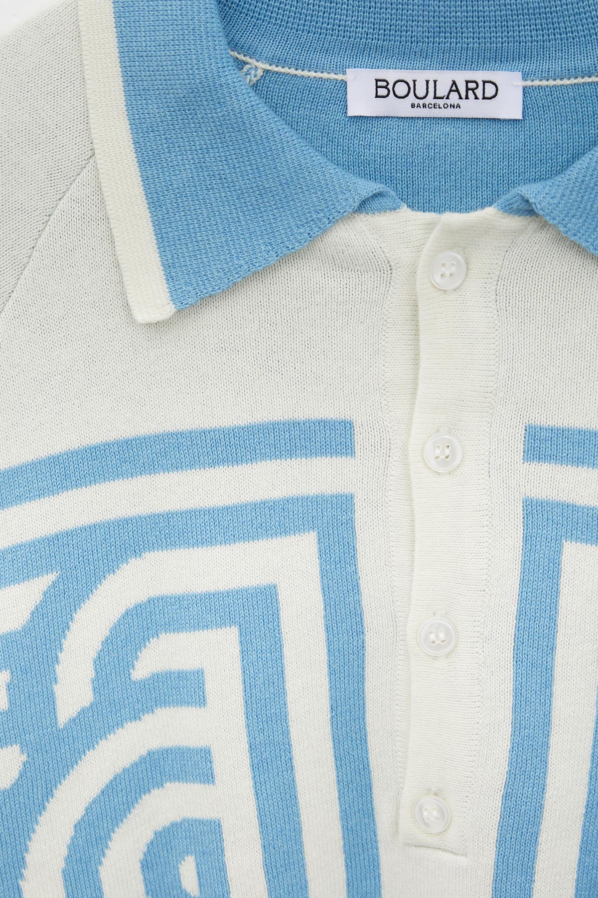 Ugo Boulard Poloshirt mit Raglanärmeln und röhrenförmigem Jacquard in Babyblau mit UB-Flagge